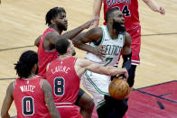 Chicago Bulls' Zach LaVine (8) strips the ball from Boston Celtics' Jaylen Brown (7) as Coby White (0) and Patrick Williams watch during the first half of an NBA basketball game Monday, Jan. 25, 2021, in Chicago. (AP Photo/Charles Rex Arbogast)