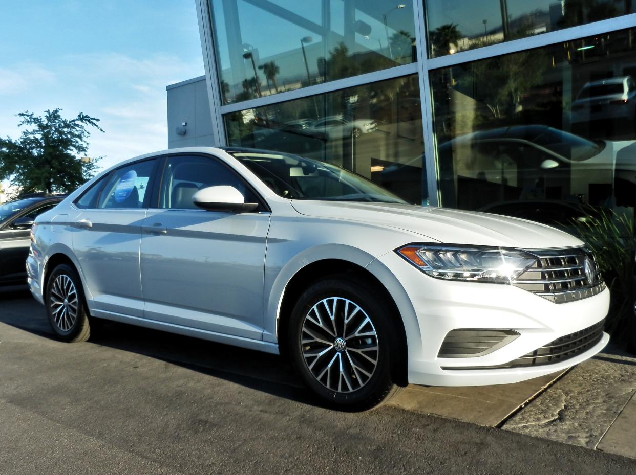 White VW Jetta in Las Vegas parked at a car dealer.