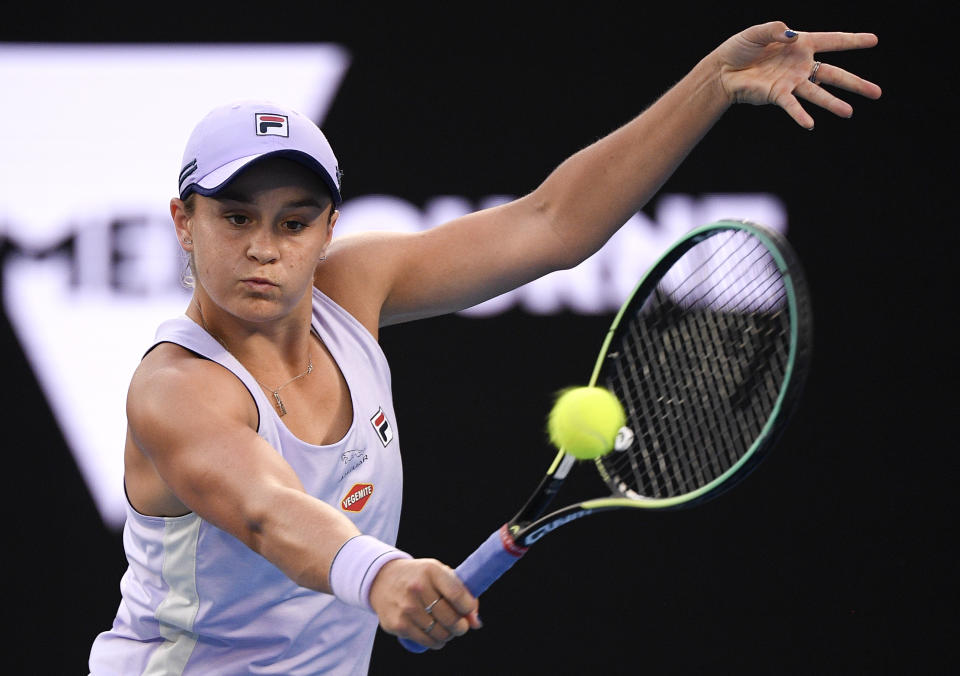 Australia's Ash Barty hits a backhand return to United States' Shelby Rogers during their fourth round match at the Australian Open tennis championship in Melbourne, Australia, Monday, Feb. 15, 2021.(AP Photo/Andy Brownbill)