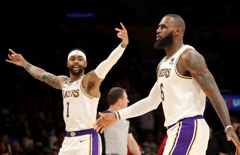 Los Angeles, CA - April 09: Lakers guard D'Angelo Russell, left, celebrates a three-pointer by forward LeBron James against the Jazz in the first quarter at Crypto.com Arena in Los Angeles on Sunday, Apr. 9, 2023. (Luis Sinco / Los Angeles Times)