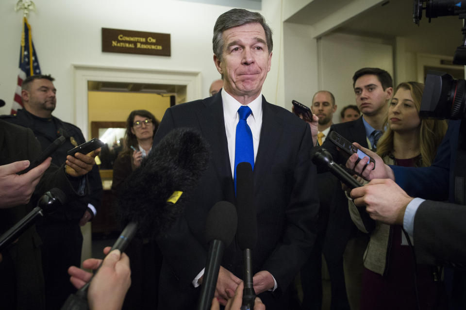 FILE - In this Feb. 6, 2019 file photo, North Carolina Gov. Roy Cooper speaks with reporters after testifying before the House Natural Resources Committee hearing on climate change, on Capitol Hill in Washington. Cooper issued executive orders designed to reduce statewide greenhouse gas emissions and bar LGBT discrimination in state employee hiring and in awarding government contracts. (AP Photo/Cliff Owen, File)