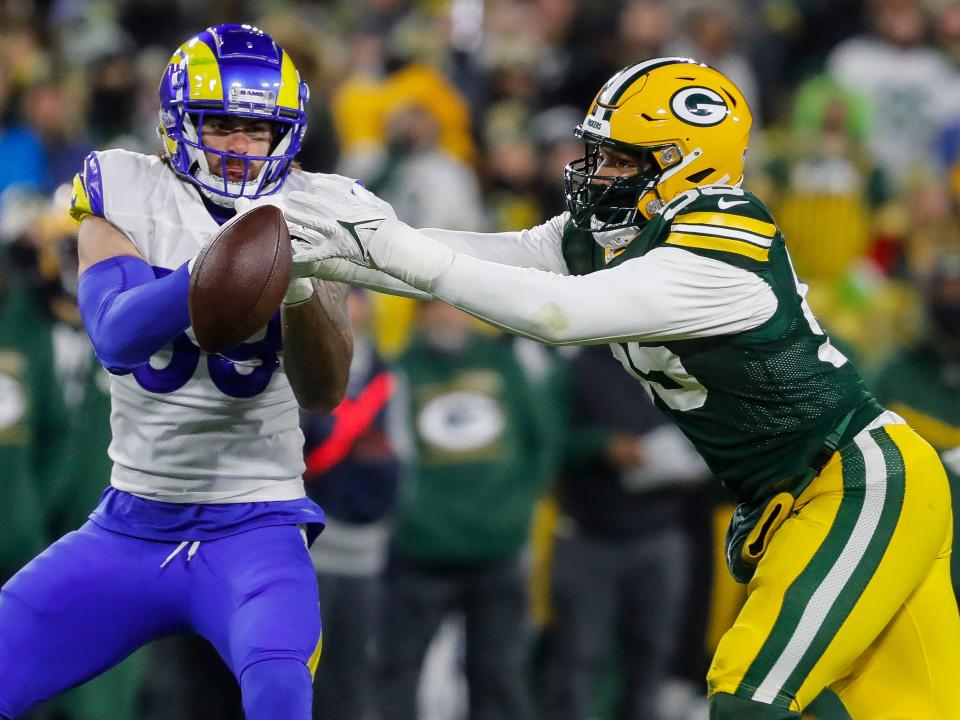 Green Bay Packers linebacker Kingsley Enagbare (right) breaks up a pass intended for Los Angeles Rams tight end Tyler Higbee (89) on Monday, Dec. 19, 2022, at Lambeau Field in Green Bay.