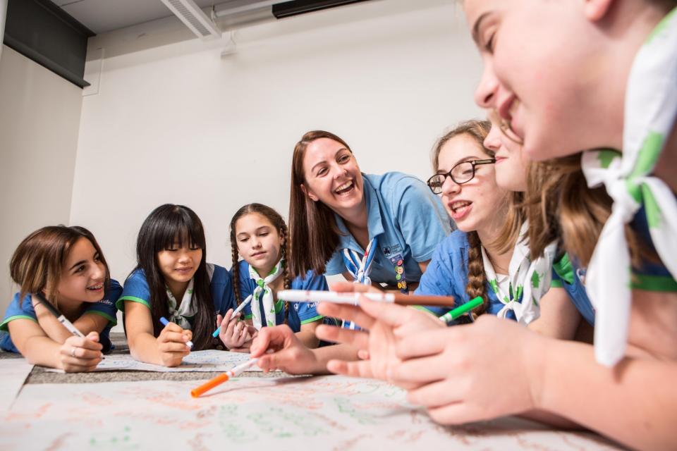 A volunteer works with a group of Pathfinders (girls aged 12-14). (Photo: Girl Guides of Canada)