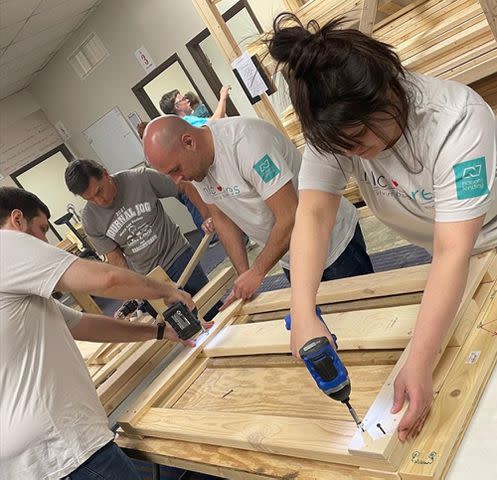 <p>Nations Lending</p> Nations Lending employees build beds at Good Knights, a Cleveland nonprofit that provides beds for children in need.