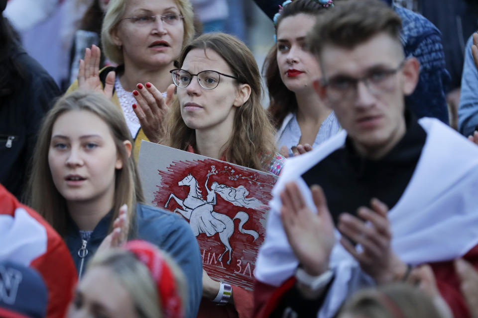 Belarusian opposition supporters applaud a speaker as they gather at Independence Square in Minsk, Belarus, Wednesday, Aug. 26, 2020. Protests demanding the resignation of Belarus' authoritarian President Alexander Lukashenko have entered their 18th straight day on Wednesday. (AP Photo/Sergei Grits)