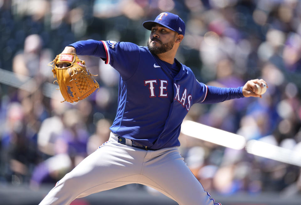 Texas Rangers starting pitcher Martin Perez works against the Colorado Rockies in the second inning of a baseball game Wednesday, Aug. 24, 2022, in Denver. (AP Photo/David Zalubowski)