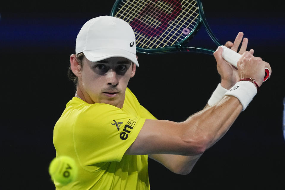 FILE - Australia's Alex de Minaur plays a backhand return to Germany's Alexander Zverev during their United Cup semifinal tennis match in Sydney, Australia, Saturday, Jan. 6, 2024. De Minaur is one of the players to watch at the Australian Open. The year's first Grand Slam tennis tournament is scheduled to start at Melbourne Park on Sunday, Jan. 14 . (AP Photo/Mark Baker, File)