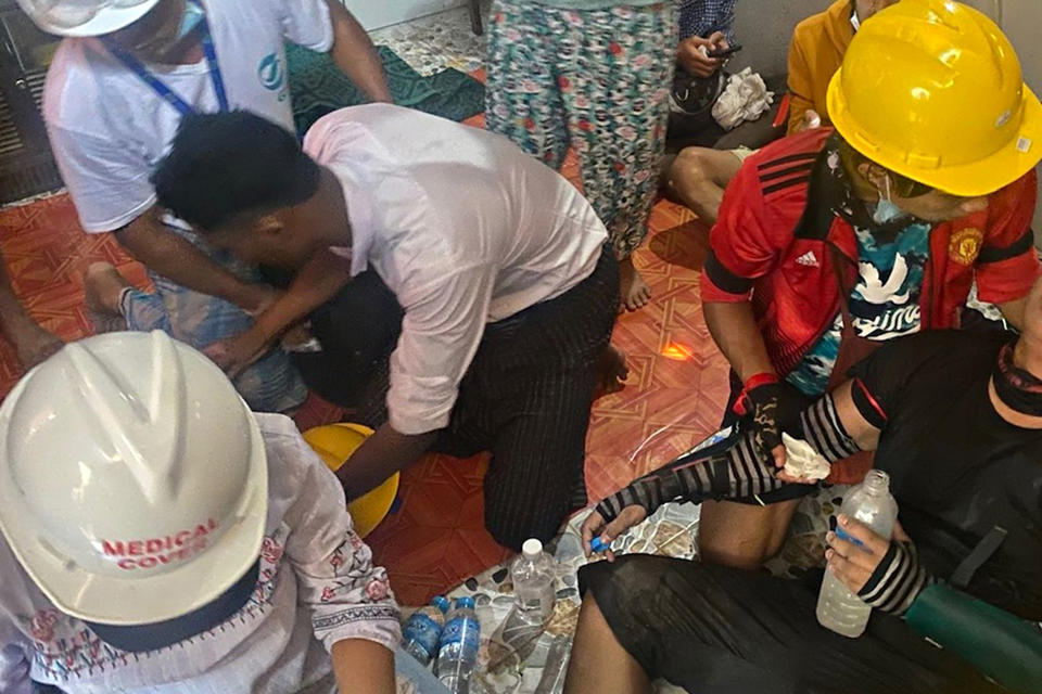 In this March 9, 2021 photo obtained by The Associated Press, doctors treat a wounded protester in a secret clinic set up in a resident's house in Yangon, Myanmar. In Myanmar, the military has declared war on health care _ and on doctors themselves, who were early and fierce opponents of the takeover in February. (AP Photo)