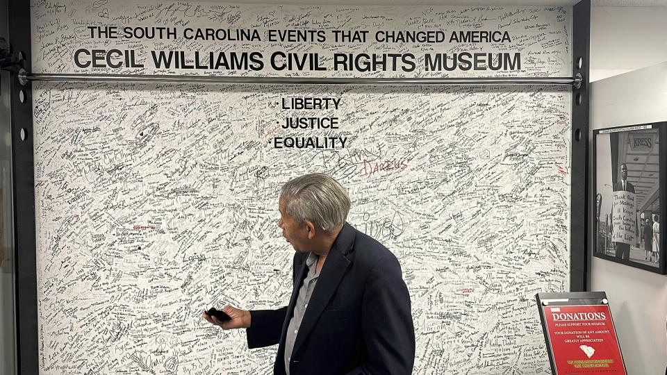 South Carolina civil rights photographer Cecil Williams shows some of the names of the 25,000 people who have visited his museum, the only civil rights museum in the state, on Tuesday, Dec. 12, 2023, in Orangeburg, South Carolina. (AP Photo/Jeffrey Collins)