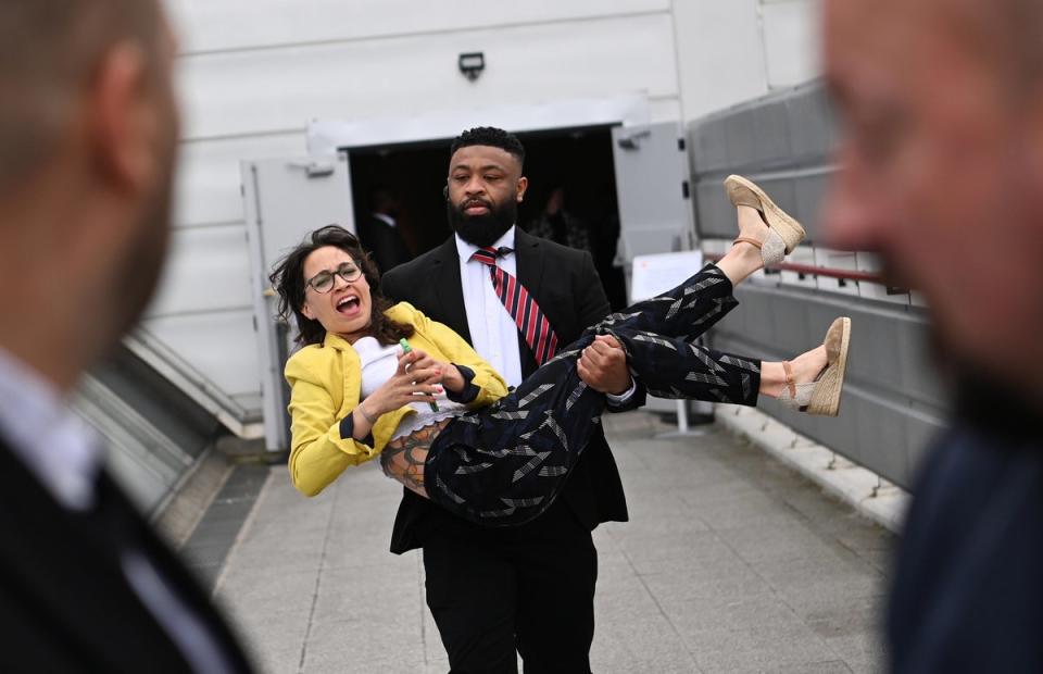 A protester is carried out of the Shell annual general shareholders meeting in London on Tuesday (EPA)