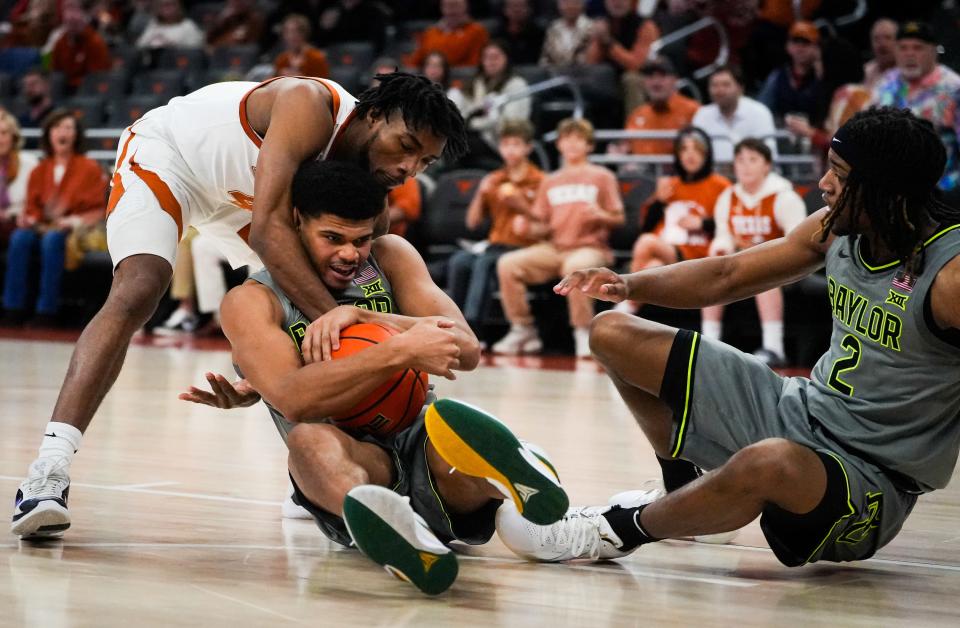 Texas guard Tyrese Hunter battles Baylor's RayJ Dennis for a loose ball during the Longhorns' 75-73 win Saturday at Moody Center. It was the last trip by Baylor to Austin for a conference game because Texas will join the SEC on July 1.