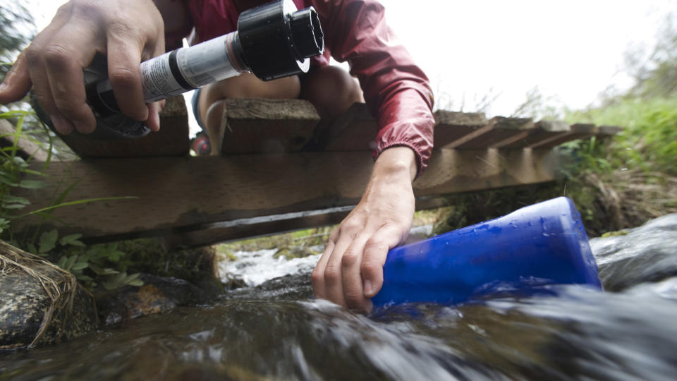 Hiker ready to use a filtration system