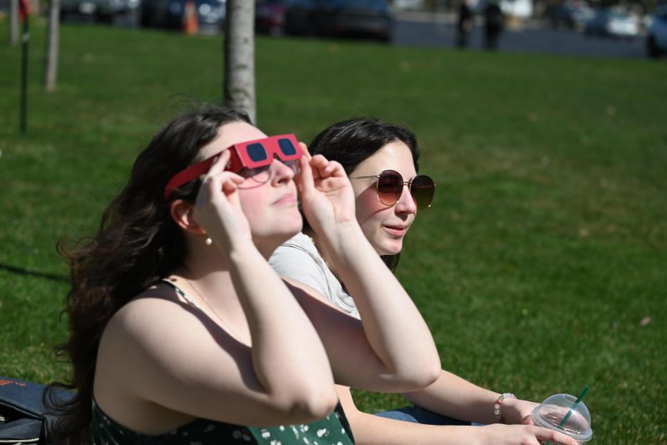 Nikkie Blume and Emerie Commisso watch the eclipse at Monday's Indiana University South Bend watch party.