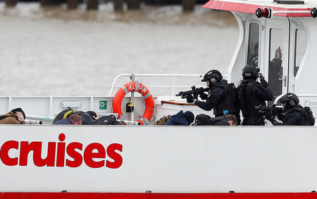 Armed counter terrorism officers of the London Metropolitan Police, take part in a training exercise to rescue hostages, played by actors, from a cruise boat on the river Thames, in London, Britain March 19, 2017. REUTERS/Peter Nicholls