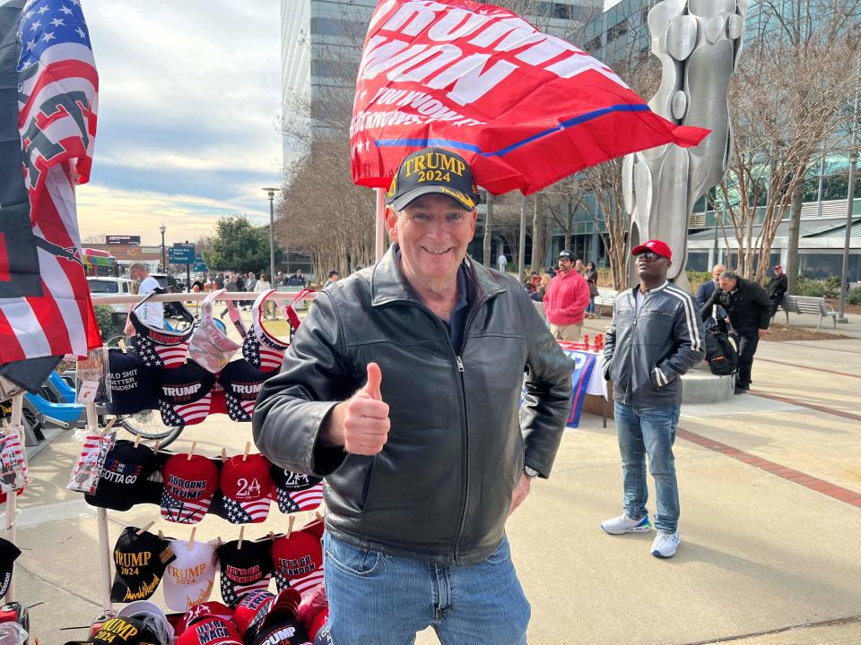 Ronald Soloman, who travelled from his home near Trump's Palm Beach estate in Florida, sells MAGA hats and other merchandise ahead of former US president Donald Trumps rally in Columbia (AFP via Getty Images)