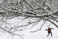 <p>A man throws a snowball in a park Wednesday, March 21, 2018, in Baltimore. A spring nor’easter targeted the Northeast on Wednesday with strong winds and a foot or more of snow expected in some parts of the region. (Photo: Patrick Semansky/AP) </p>