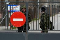 Greek soldiers stand guard at the closed Kastanies border crossing with Turkey's Pazarkule, in the region of Evros