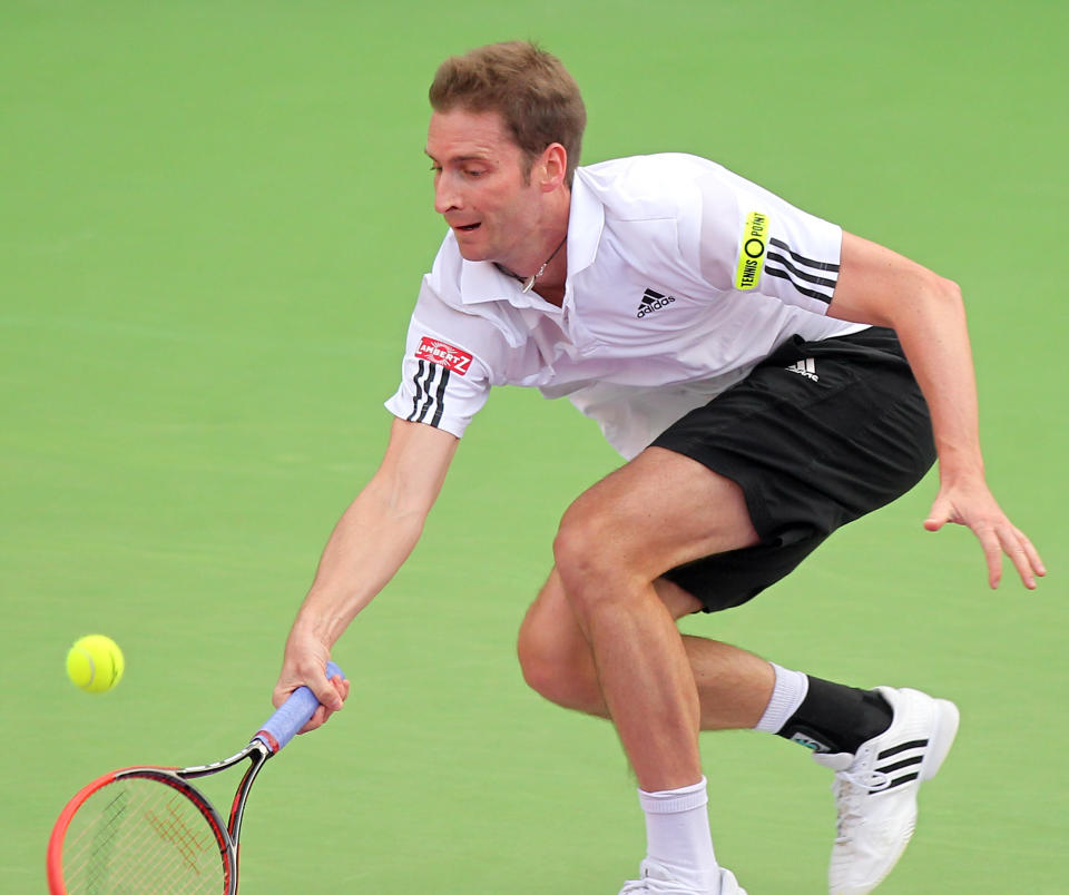 Florian Mayer of Germany returns the ball to Andy Murray of Great Britain during the Qatar ATP Open Tennis tournament in Doha, Qatar, Wednesday, Jan. 1, 2014.(AP Photo/Osama Faisal)