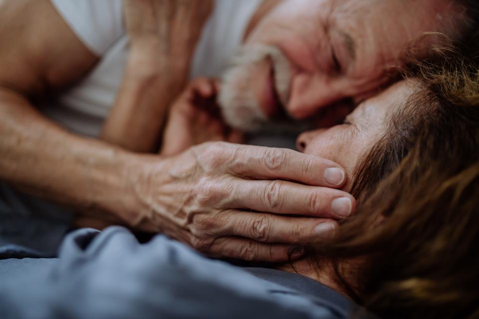 Old couple cuddling.