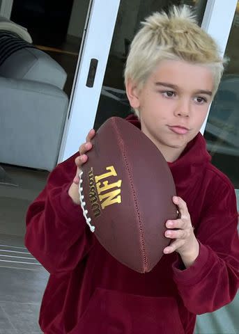 <p>Scott Disick/Instagram</p> Reign Disick holding a football