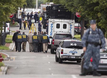 Police walk in the Washington Navy Yard after a shooting in Washington on September 16, 2013. REUTERS/Joshua Roberts