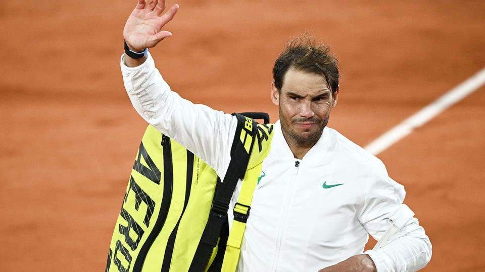 Pictured here, Rafael Nadal waves to fans at the French Open.