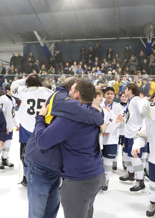 Head coach Ed Witz (l) and assistant Mike Cambria (r) embrace following the medal ceremony after their Pelham ice hockey team won the Section 1 Division 2 title February 27, 2022 at Sport-O-Rama.