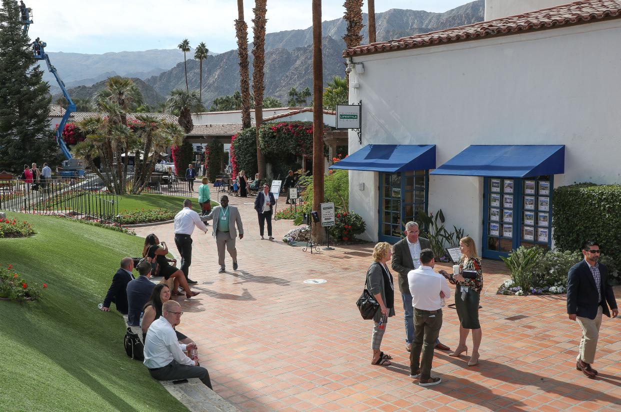 Attendees of the National Association of Regulatory Utility Commissioners annual meeting network and gather outside during perfect November weather at the La Quinta Hotel and Resort in La Quinta, Calif., Nov. 13, 2023.