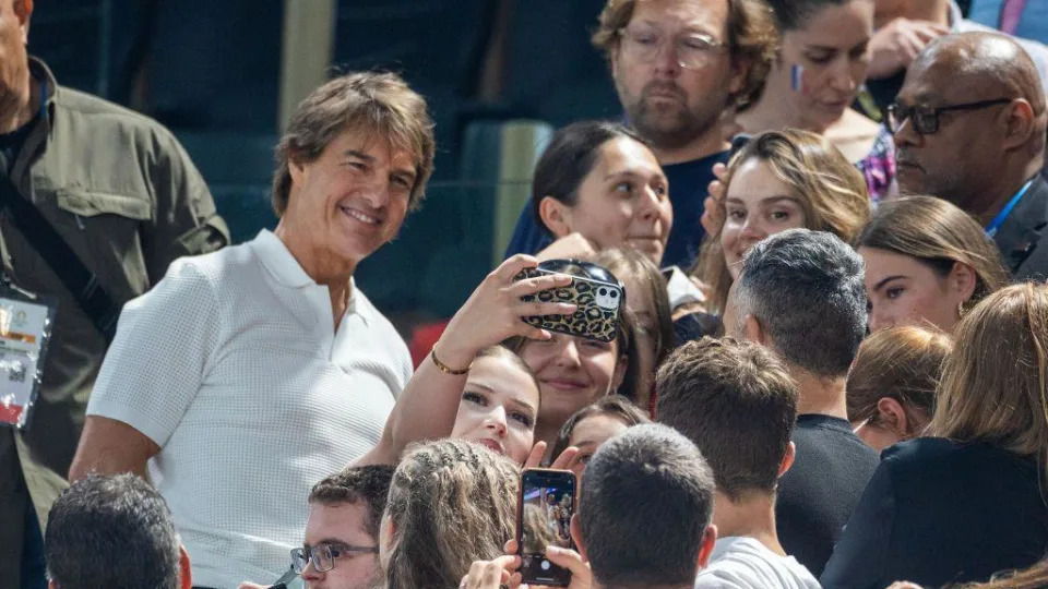 Tom Cruise poses for a selfie with a fan in Paris