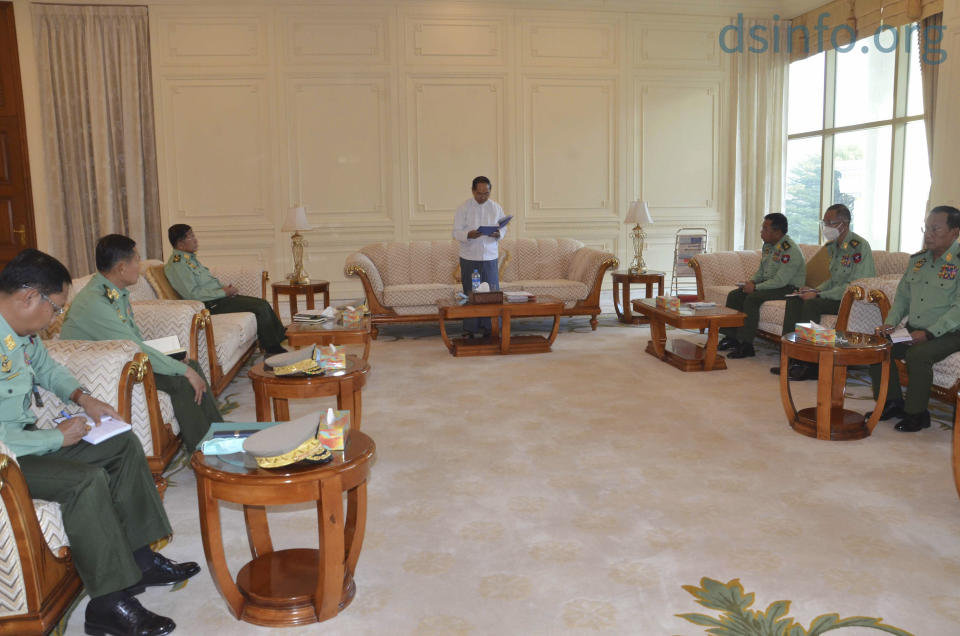 In this photo released by The Military True News Information Team, Myanmar Acting President Myint Swe, center, military chief Senior Gen. Min Aung Hlaing, third left, and other military members of National Defence and Security Council attend a meeting at Presidential Palace in Naypyitaw, Myanmar Monday, Feb. 1, 2021. (The Military True News Information Team via AP)