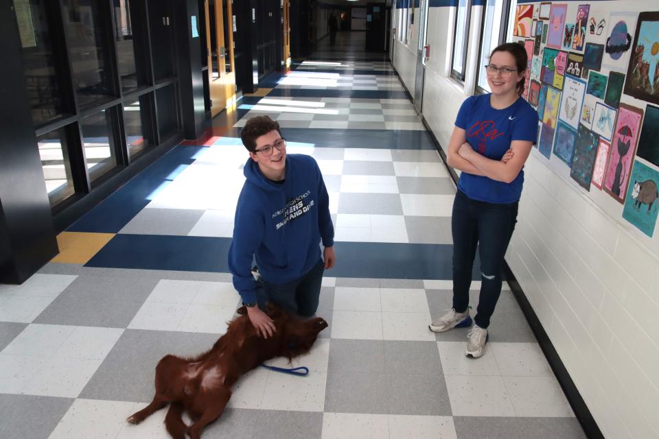 Charlie, the Adrian school district's police and therapy dog, rolls over for a belly rub from sophomore Noah Judson, pictured with his sister, sophomore Claire Judson, Wednesday, Feb. 7, 2024, at Adrian High School.