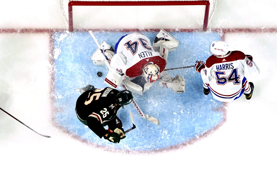 Montreal Canadiens goaltender Jake Allen (34) and defenseman Jordan Harris (54) defend the goal against Minnesota Wild defenseman Jonas Brodin (25) during the second period of an NHL hockey game Tuesday, Nov. 1, 2022, in St. Paul, Minn. (AP Photo/Abbie Parr)