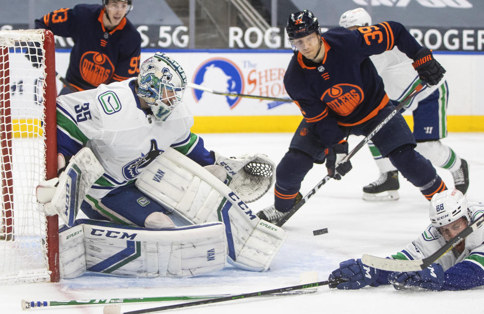 Edmonton Oilers' Alex Chiasson (39) is stopped by Vancouver Canucks goalie Thatcher Demko (35) during the second period of an NHL hockey game Saturday, May 8, 2021, in Edmonton, Alberta. (Jason Franson/The Canadian Press via AP)