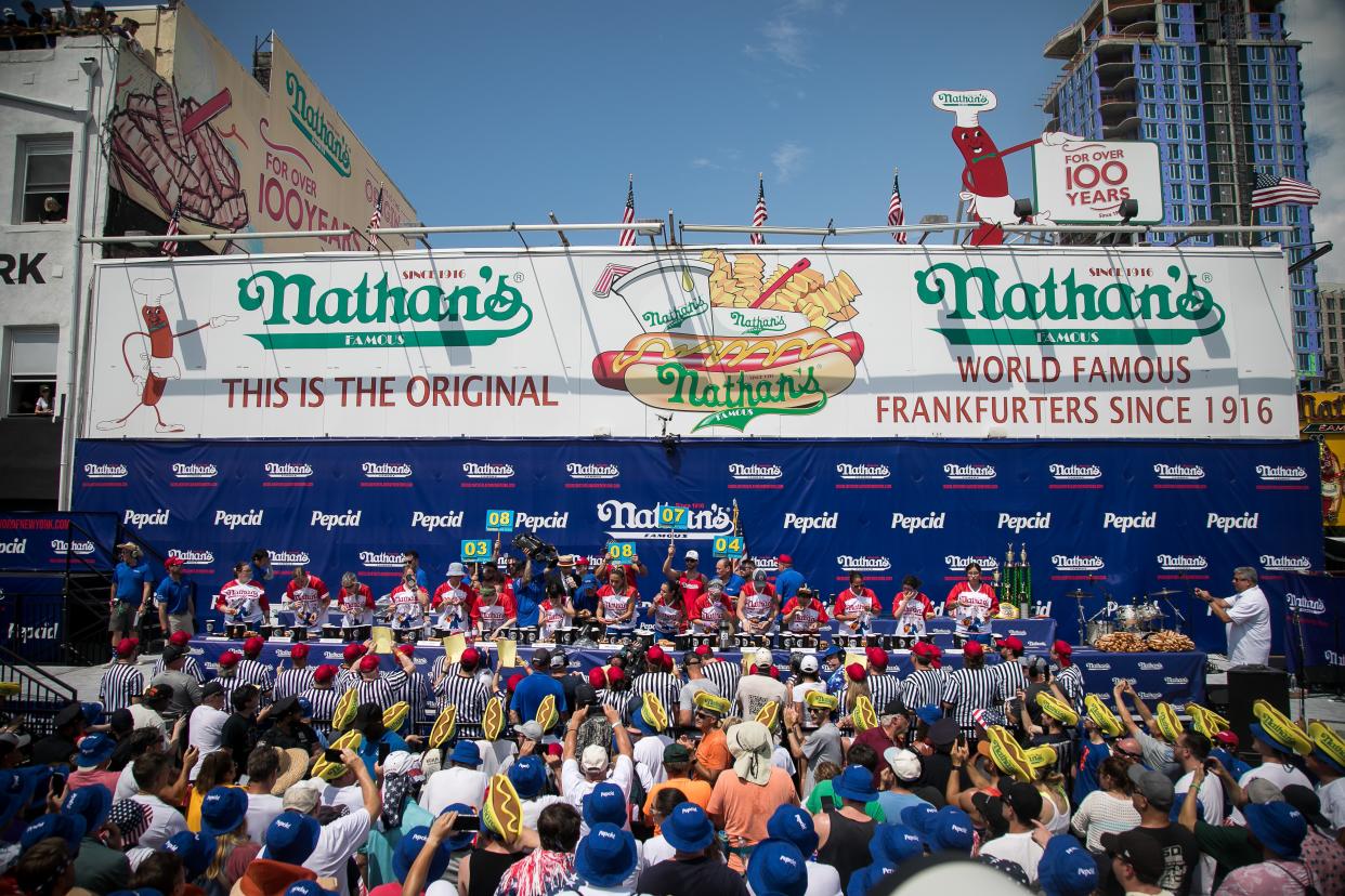 Contestants compete during a hot dog eating contest at Coney Island, New York City, the United States, on July 4, 2023. Named the Nathan's Famous Fourth of July International Hot Dog Eating Contest, the annual event has occurred each July 4 on Coney Island since 1916, according to archives. Joey Chestnut, 39, won the first place for the 16th time by eating 62 hot dogs and buns in 10 minutes. Miki Sudo, 37, won the women's championship for the ninth time on Tuesday morning by consuming 39.5 hot dogs and buns in 10 minutes. (Photo by Michael Nagle/Xinhua via Getty Images)