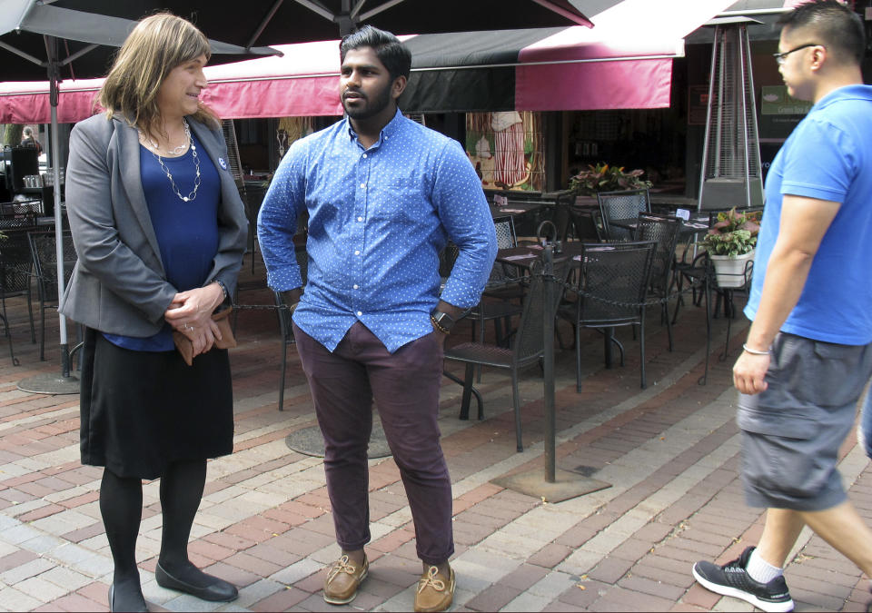 In this Aug. 9, 2018 photo, Christine Hallquist, transgender candidate seeking the Democratic party nomination to run for governor of Vermont, speaks with supporter Asfar Basha in Burlington, Vt. Vermont's state primary election is scheduled for Tuesday, Aug. 14. (AP Photo/Wilson Ring)