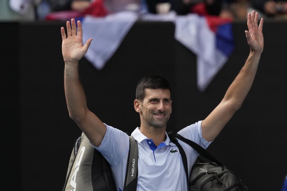 Novak Djokovic of Serbia waves as he leaves Rod Laver Arena following his loss to Jannik Sinner of Italy in their semifinal at the Australian Open tennis championships at Melbourne Park, Melbourne, Australia, Friday, Jan. 26, 2024. (AP Photo/Alessandra Tarantino)