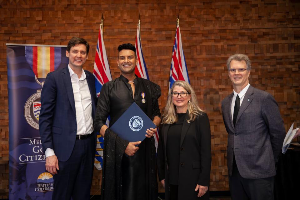 Premier David Eby and MLA Fin Donnelly present Vishad Deeplaul with a Medal of Good Citizenship from the government of British Columbia in Vancouver, British Columbia on Thursday, January 25, 2024. 