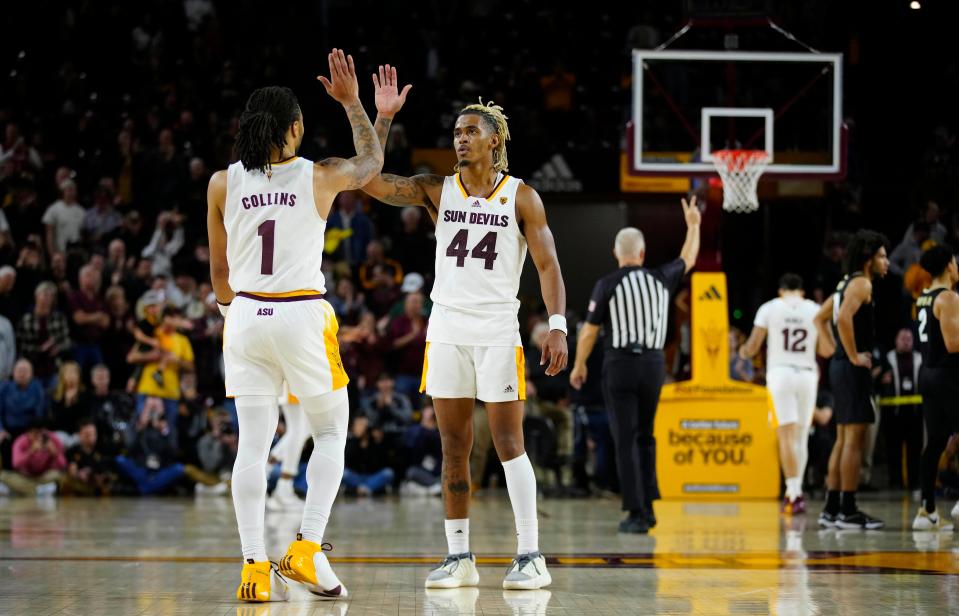 ASU guards Frankie Collins and Adam Miller (44) celebrate a win against Colorado during a game at Desert Financial Arena. The Sun Devils are 4-0 in Pac-12 play to start conference games.