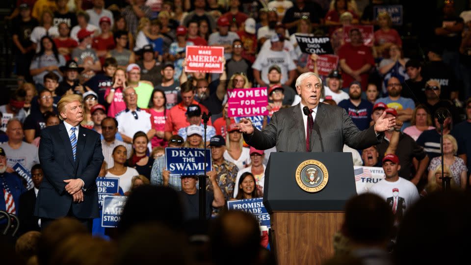 In this August 2017 photo, West Virginia Governor Jim Justice announces that he is switching parties to become a republican as President Donald J. Trump listens on at a campaign rally at the Big Sandy Superstore Arena in Huntington, West Virginia. - Justin Merriman/Getty Images