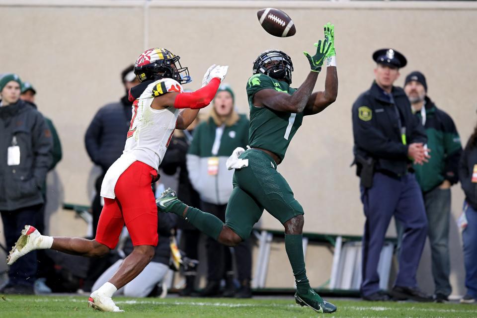 Jayden Reed (1) of the Michigan State Spartans catches a touchdown pass against Tarheeb Still (12) of the Maryland Terrapins in the first half at Spartan Stadium on Nov. 13, 2021 in East Lansing, Michigan.