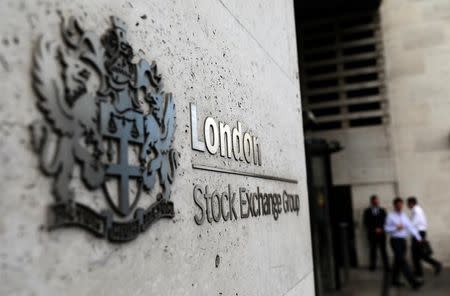 FILE PHOTO: Pedestrians leave and enter the London Stock Exchange in London, Britain August 15, 2017. REUTERS/Neil Hall