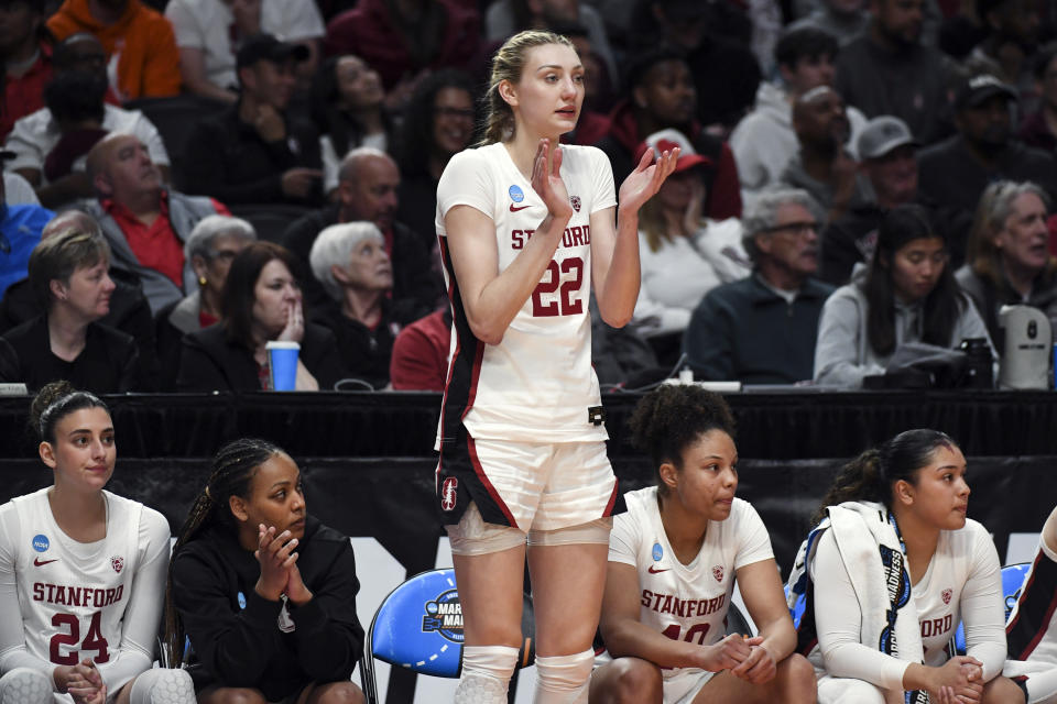 Stanford forward Cameron Brink (22) cheers from the bench after fouling out during the second half of a Sweet 16 college basketball game in the NCAA Tournament against North Carolina State, Friday, March 29, 2024, in Portland, Ore. North Carolina State won 77-67. (AP Photo/Steve Dykes)