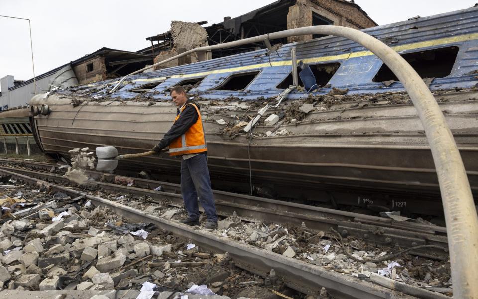 Workers clear debris from a train depot that was hit by missiles overnight on September 28 2022 in Kharkiv - Paula Bronstein/Getty Images