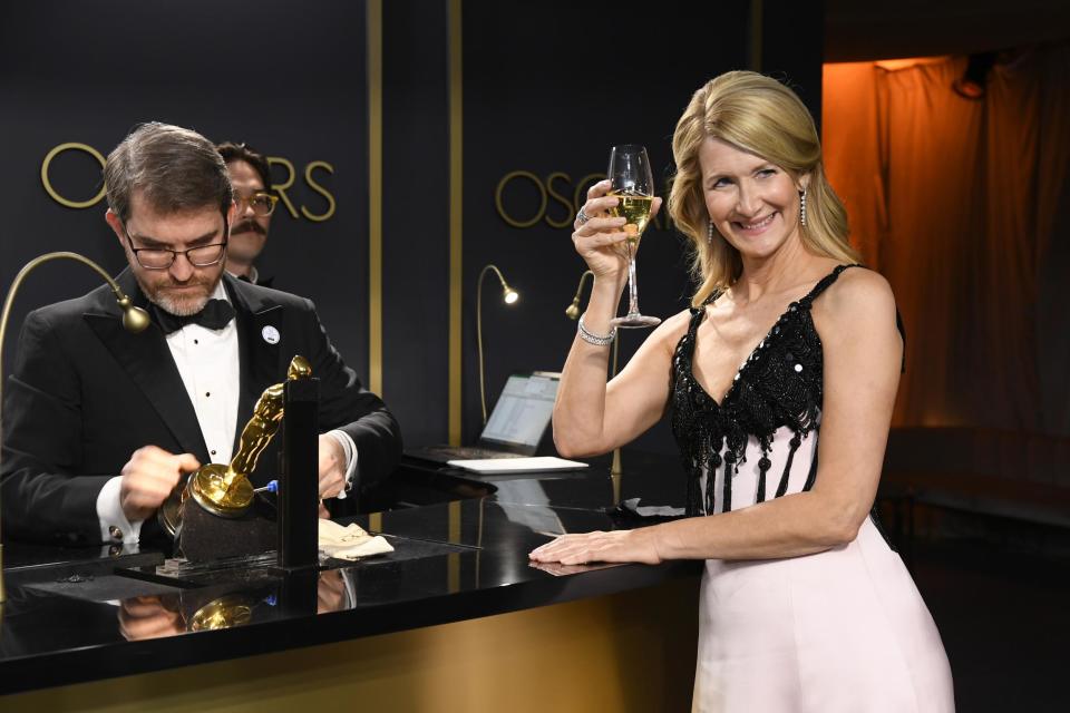 Making it official: A delighted Dern watched as her name was etched onto the Academy Award (Getty Images)