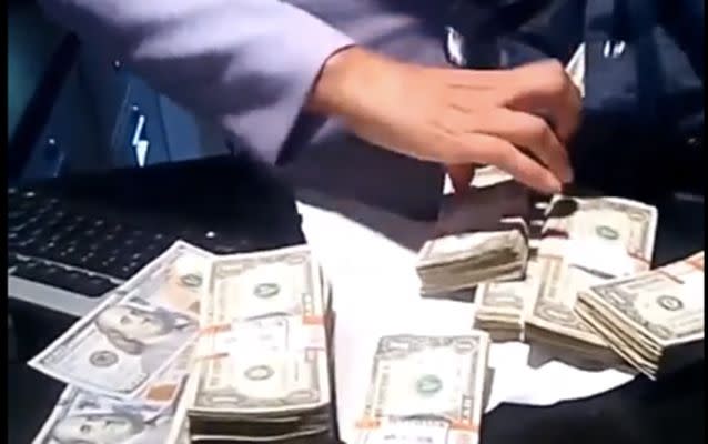 The video Alfonseca loaded to his Instagram account shows a bank teller putting  money into a bag.