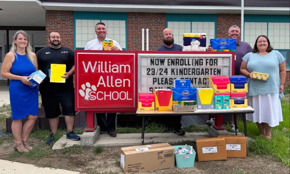 Heather Vitagliano-Ricard and Matt Negm from Club Victoire drop off school supplies at the William Allen School.