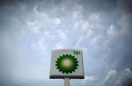 Storm clouds form near a BP station in Alexandria, Virginia July 19, 2010. REUTERS/Molly Riley/File Photo