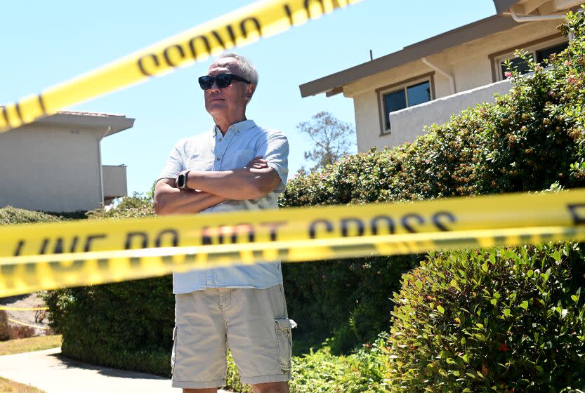 Rolling Hills Estates, California July 11, 2023-Homeowner Webber "Wei" Yen stands next to caution tape near his home that was caught in a landslide in Rolling Hills Estates. (Wally Skalij/Los Angles Times)