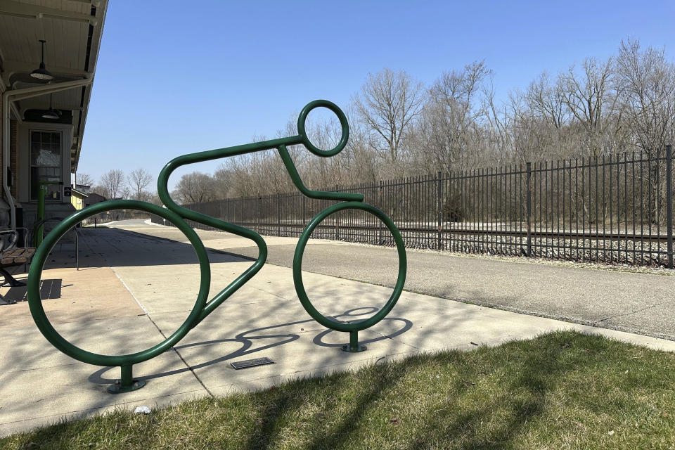 A sculpture depicts a cyclist outside of the Muncie Depot trailhead on the Cardinal Greenway in Muncie, Ind. Wednesday, March 13, 2024. The Cardinal Greenways pathway born from eastern Indiana's abandoned railroad tracks will become a central cog in the Great American Rail Trail — a planned 3,700-mile network of uninterrupted trails spanning from Washington state to Washington, D.C. (AP Photo/Isabella Volmert)