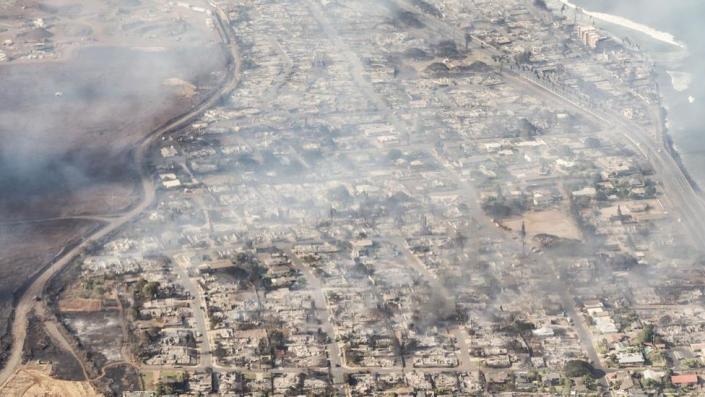 A handout photo made available by Carter Barto shows an arial view of buildings damaged in Lahaina, Hawaii as a result of a large wildfire which has killed 6 people and forced thousands of evacuations on the island of Maui in Hawaii, USA, 09 August 2023. Winds from Hurricane Dora, which is currently over the Pacific Ocean hundreds of miles south of Hawaii, have intensified the wildfires.